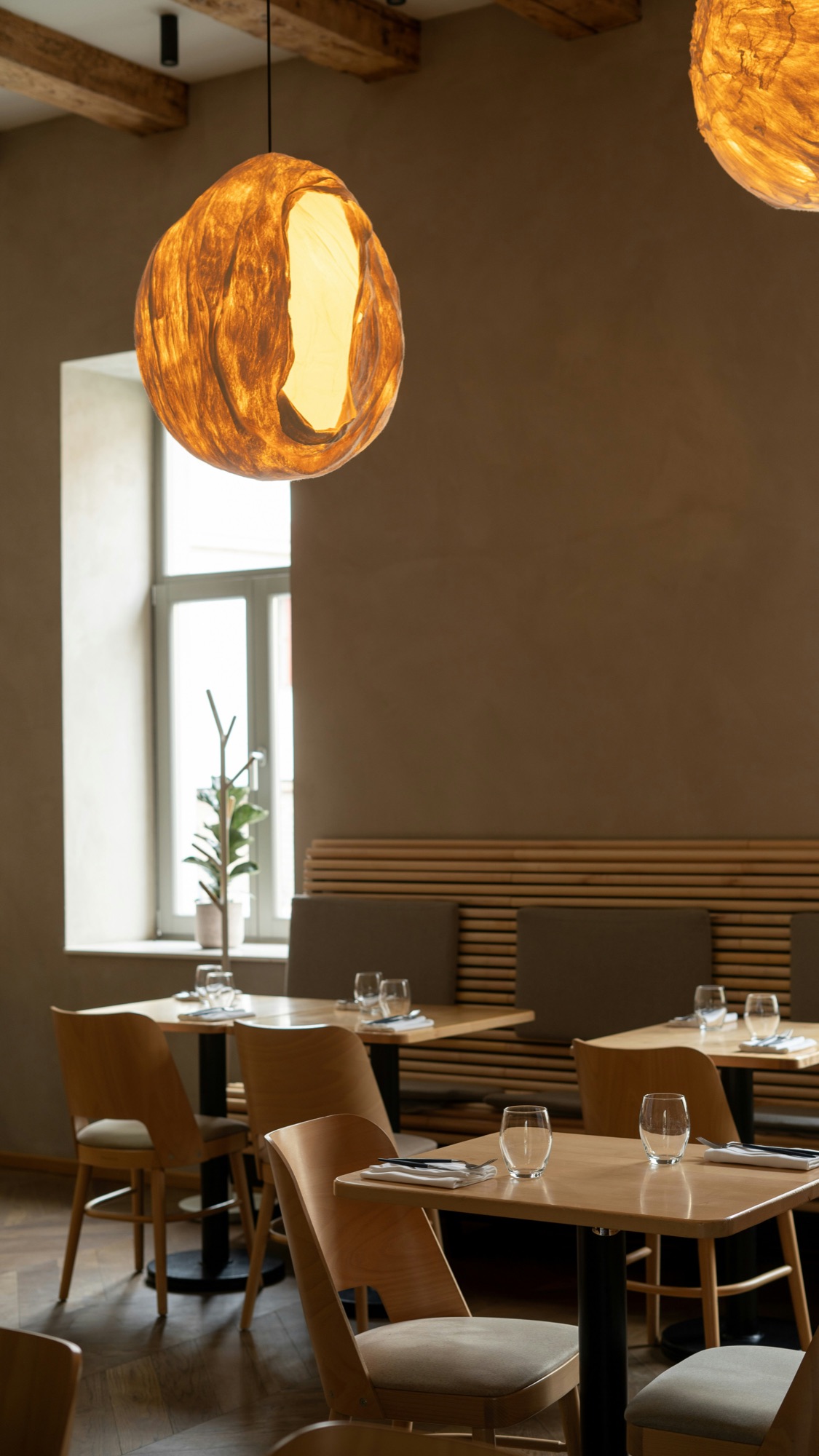 A quiet restaurant dining room with set tables